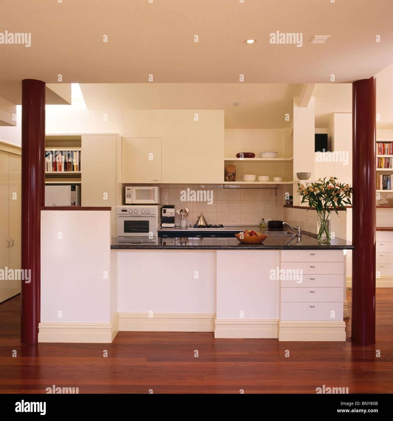 Granitetopped white fitted units in modern white kitchen extension