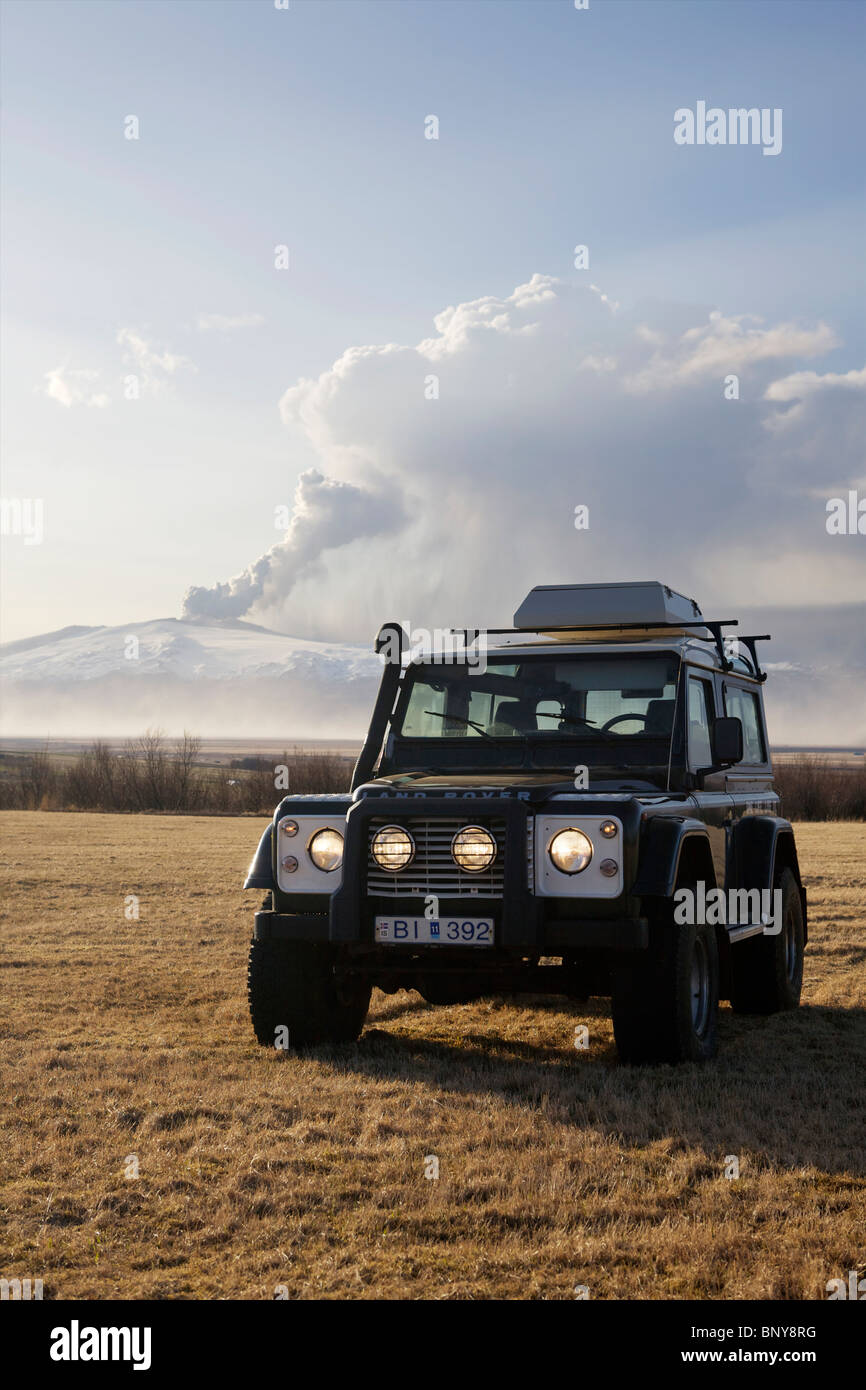 Land Rover Defender 90 300TDI in front of Eyjafjallajokull Volcan erupting in the background Stock Photo