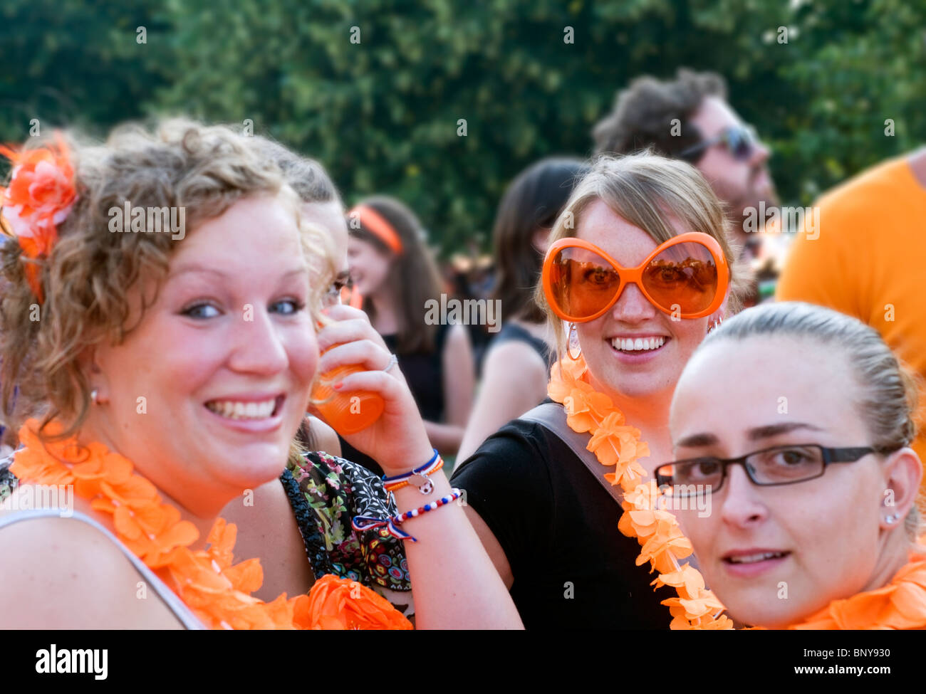 Young women dressed in orange for a party in the center of Amsterdam, the Netherlands Stock Photo