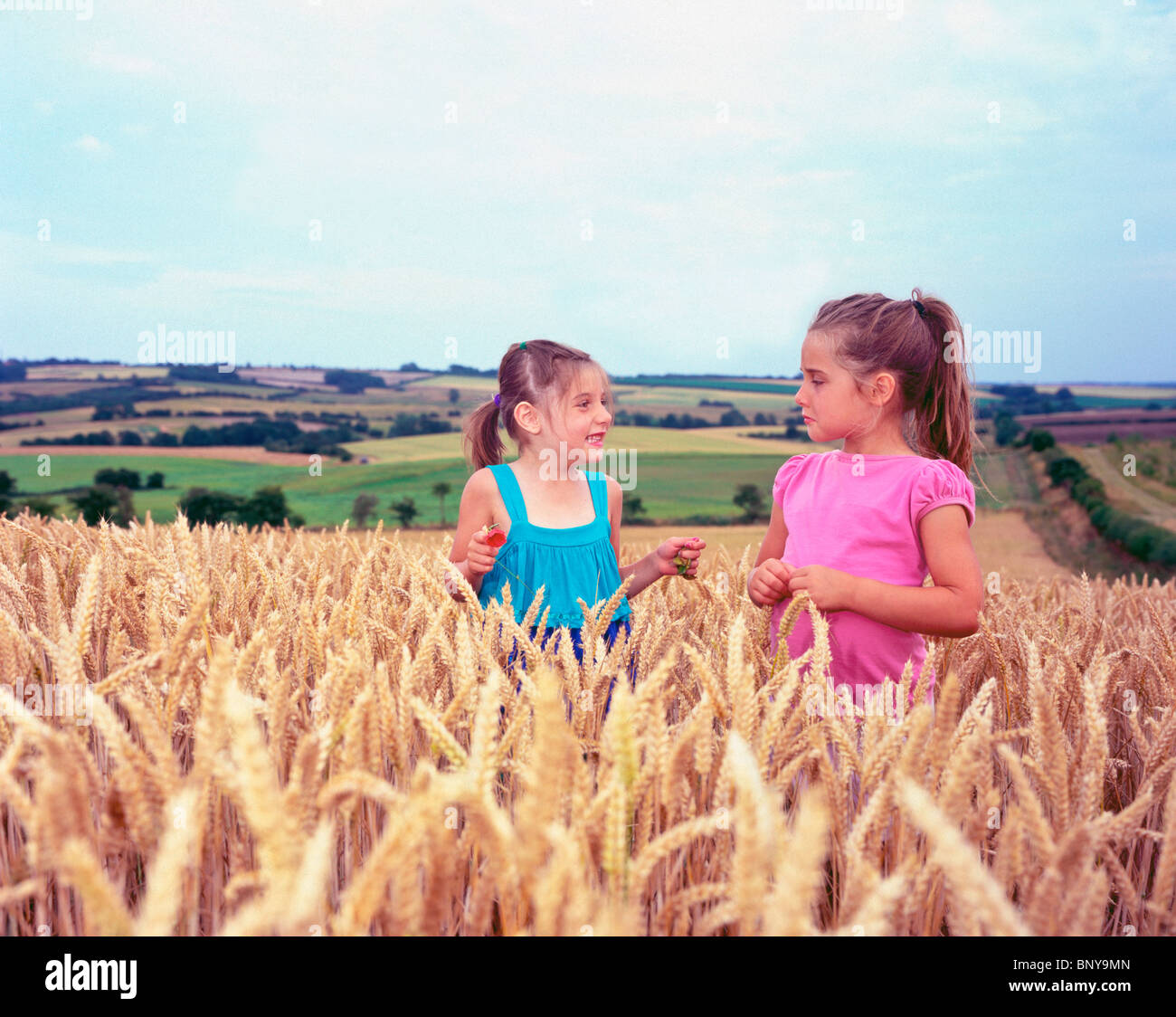 two young girls in wheat field Stock Photo - Alamy