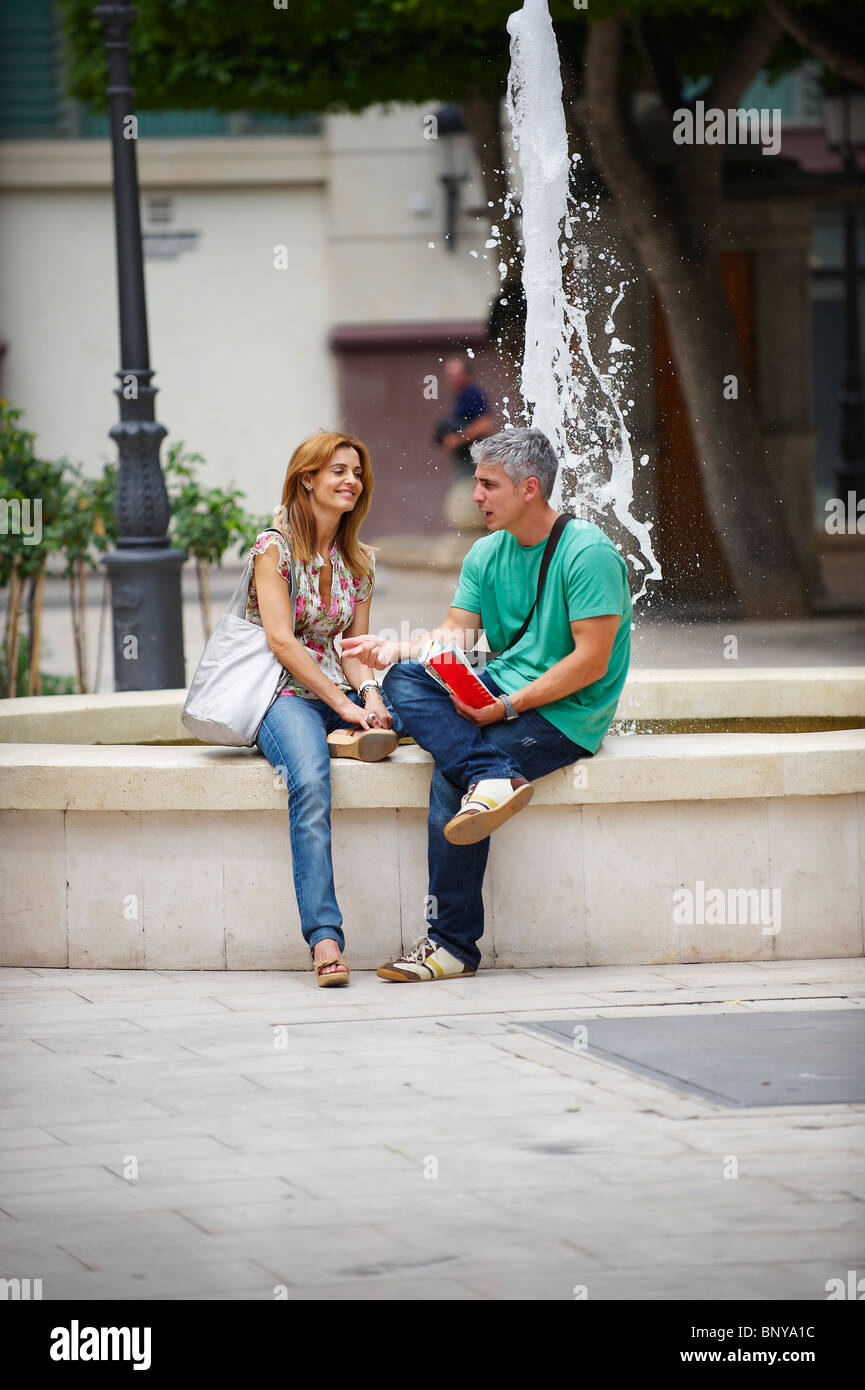 Tourist couple by fountain Stock Photo