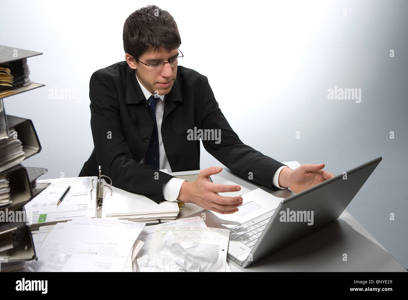An accountant with paperwork and laptop Stock Photo