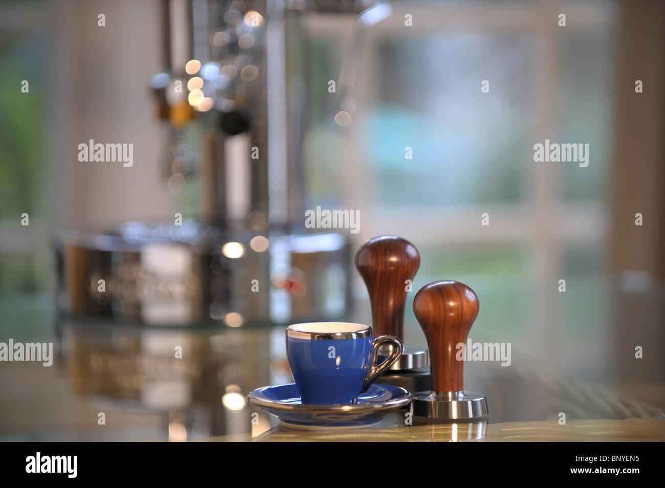 Blue espresso coffee cup and saucer with coffee tampers and espresso
