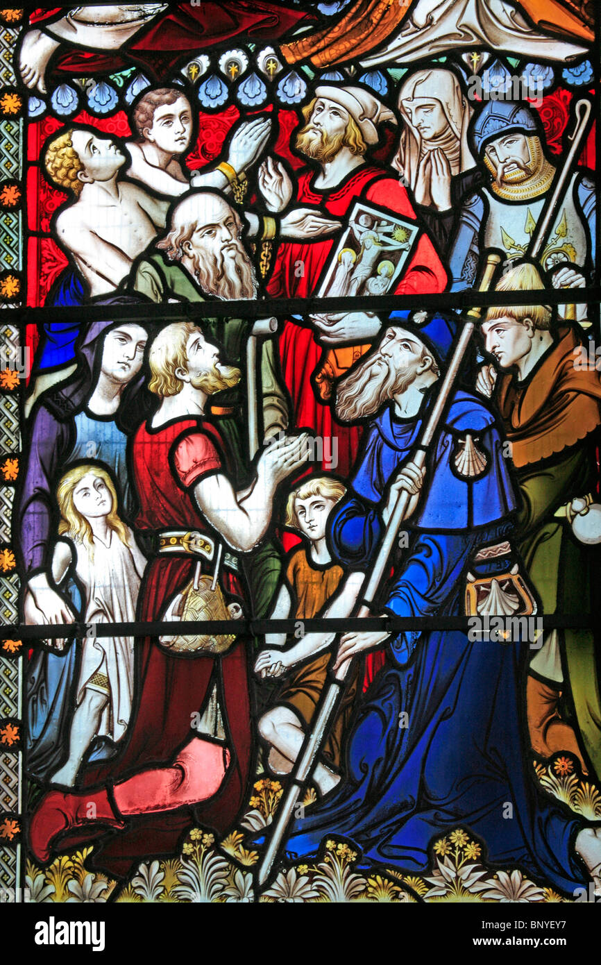 A stained glass window designed by John Hardman Powell depicting various saints and apostles, All Saints Church, Ladbroke, Warwickshire Stock Photo
