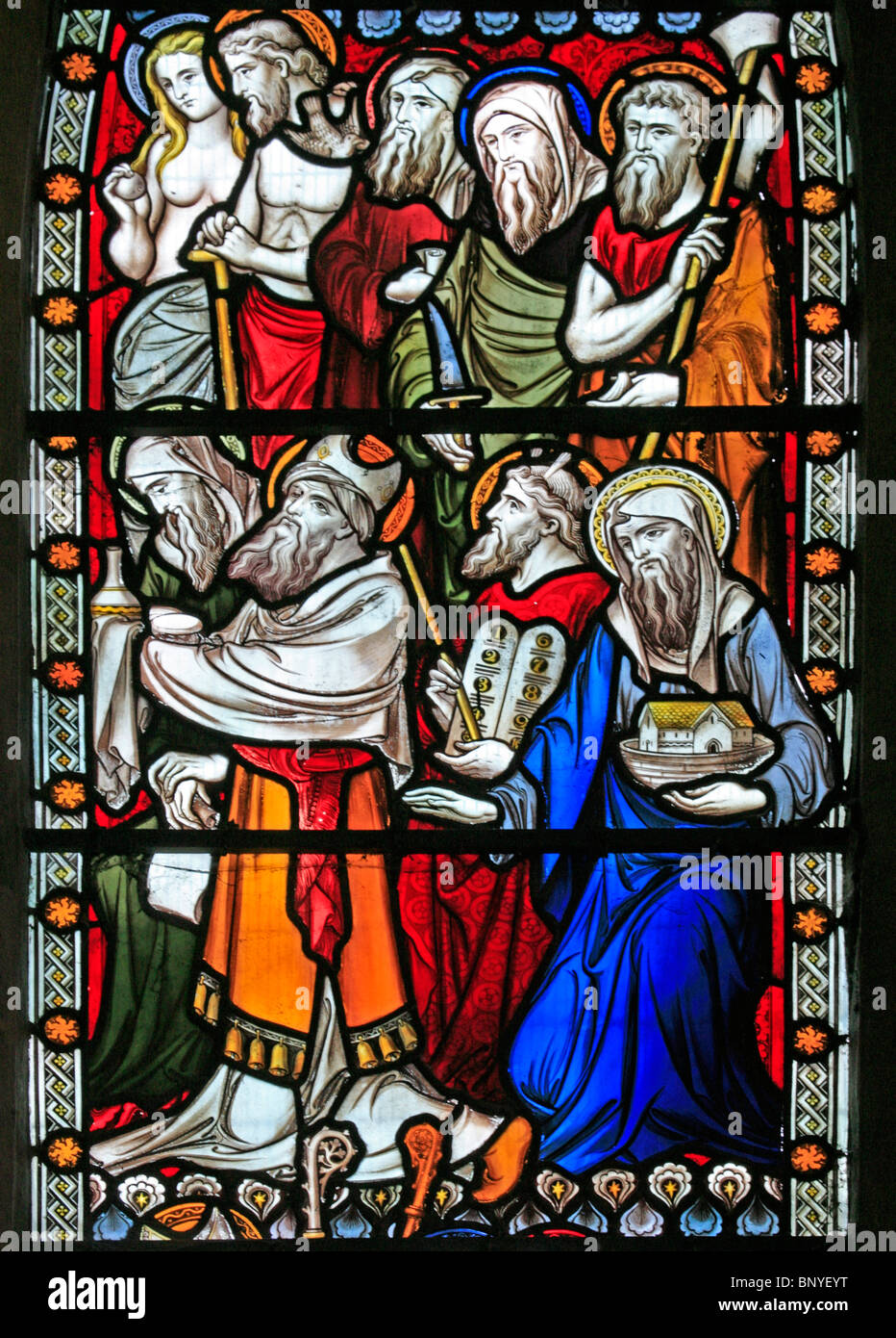 A stained glass window designed by John Hardman Powell depicting figures from the Old and NewTestaments, All Saints Church, Ladbroke, Warwickshire Stock Photo