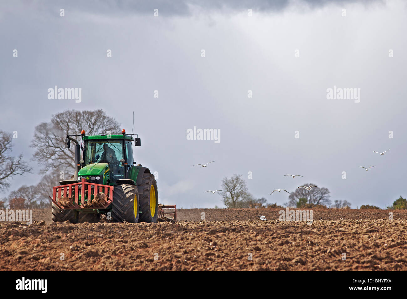 John Deere tractor harrowing a field in Perthshire Stock Photo - Alamy