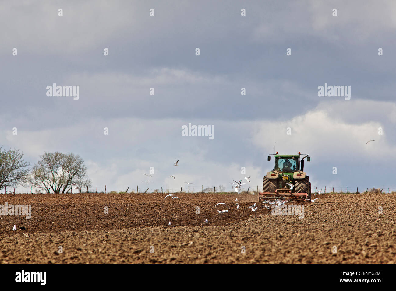 John deere tractor harrowing field hi-res stock photography and images ...