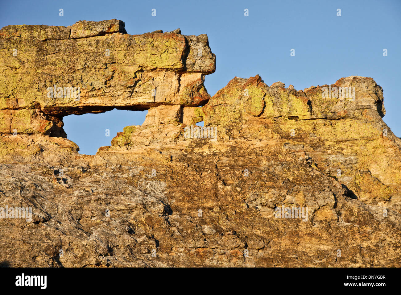 The Window of Isalo, a naturally eroded hole in sandstone rock, photographed at sunset. Isalo National Park, SW Madagascar Stock Photo
