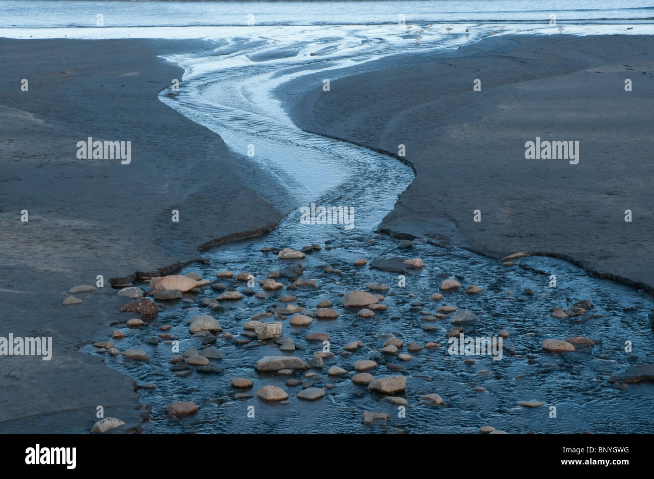 Outgoing tide on York Beach, Maine at the end of the day Stock Photo ...