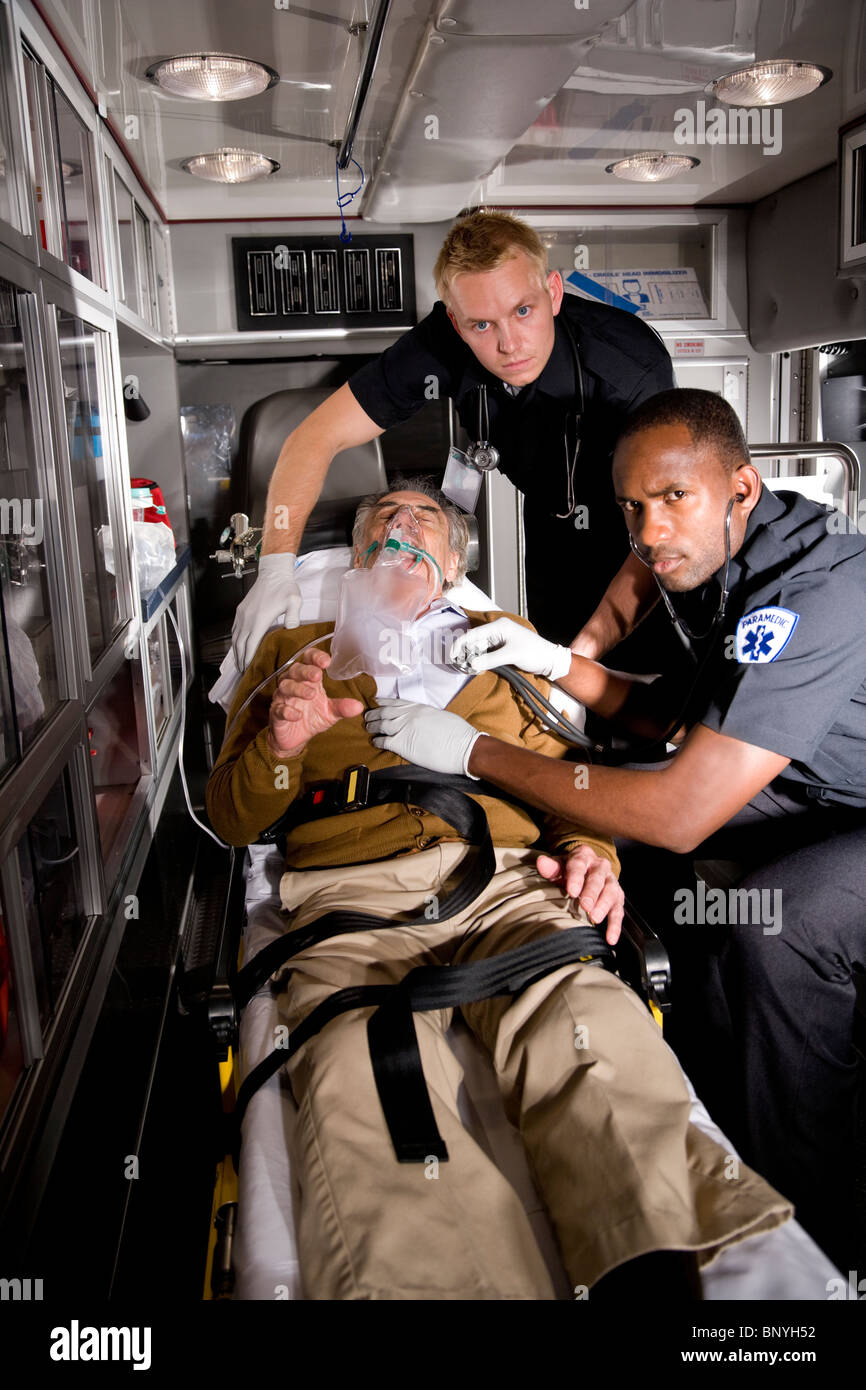 Paramedics caring for elderly patient in ambulance Stock Photo Alamy