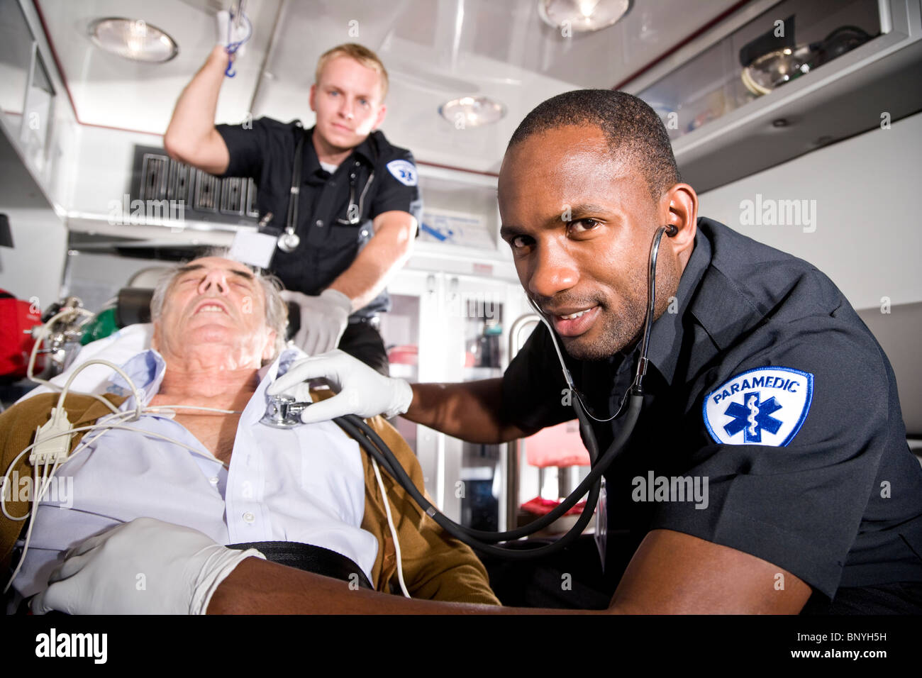 Paramedics caring for elderly patient in ambulance Stock Photo Alamy