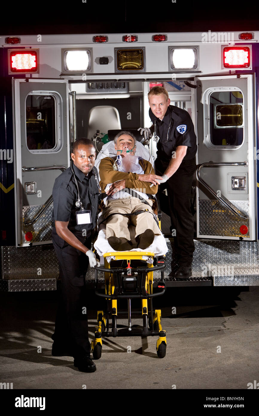 Paramedics caring for elderly patient in ambulance Stock Photo Alamy