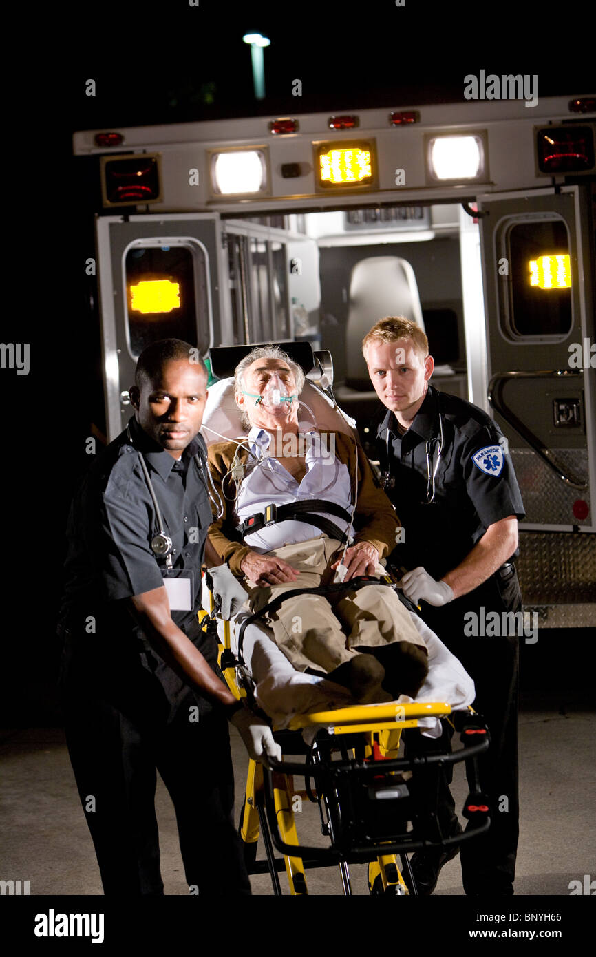 Paramedics caring for elderly patient in ambulance Stock Photo Alamy