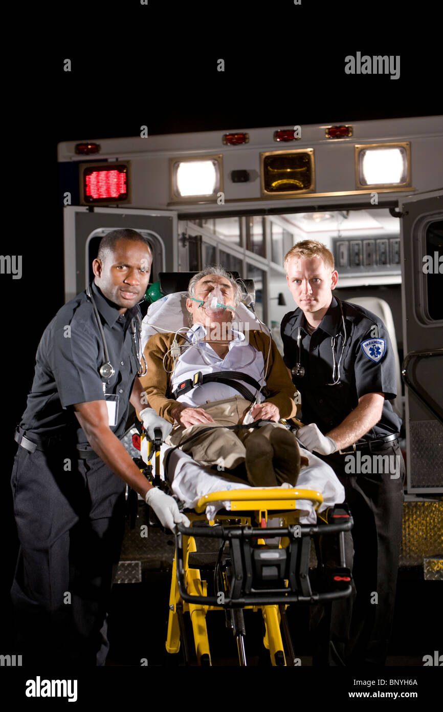 Paramedics caring for elderly patient in ambulance Stock Photo Alamy