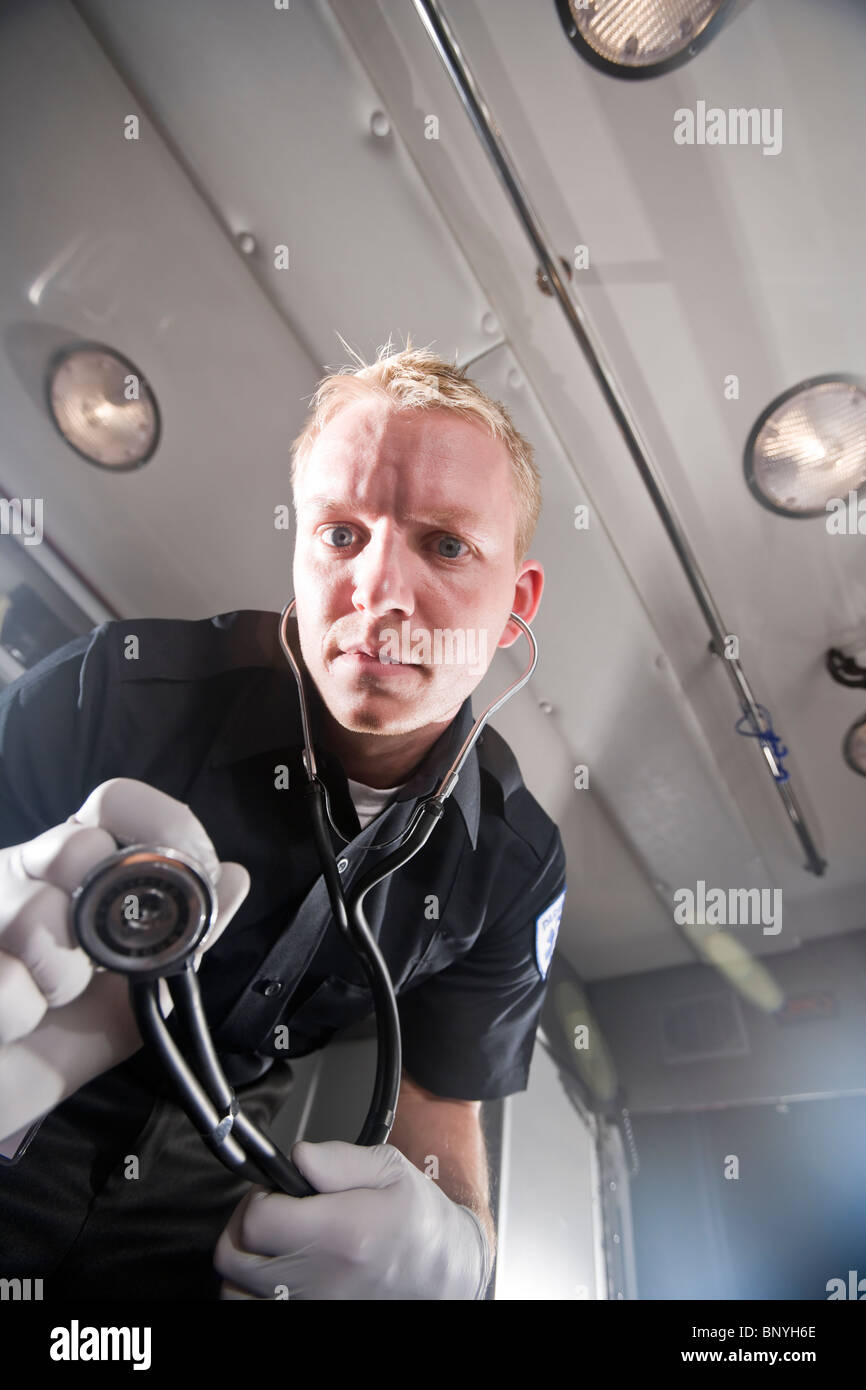 Low angle view of paramedic in ambulance working on patient Stock Photo