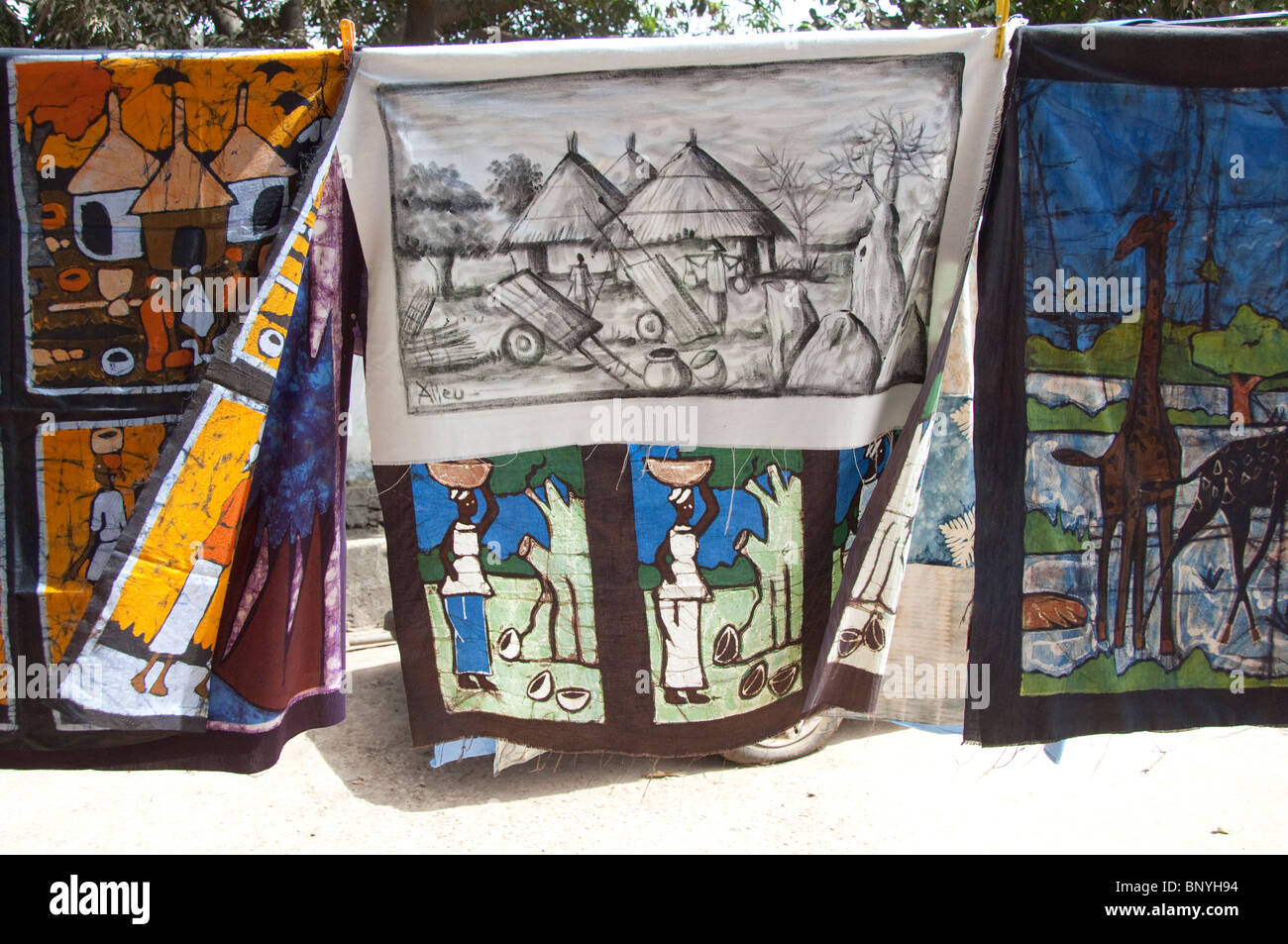 Africa, Gambia. Capital city of Banjul. Local batik workshop. Hanging hand made textiles. Stock Photo