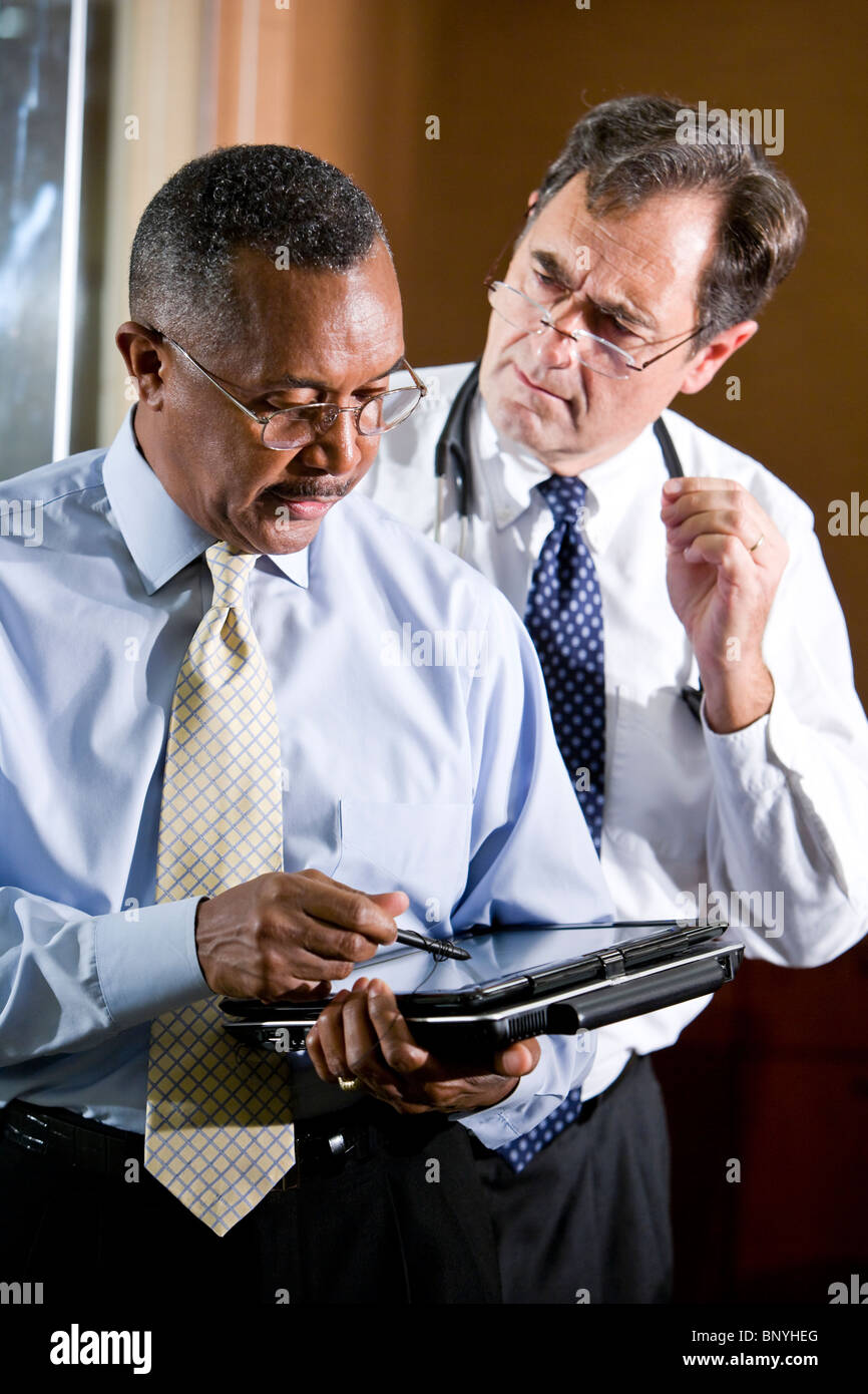 Two mature multiracial doctors conversing Stock Photo
