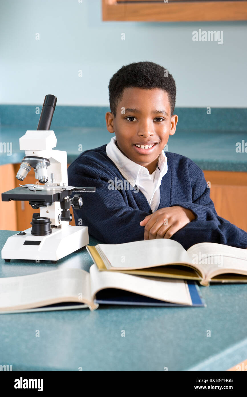 Elementary school boy with microscope in science lab Stock Photo Alamy