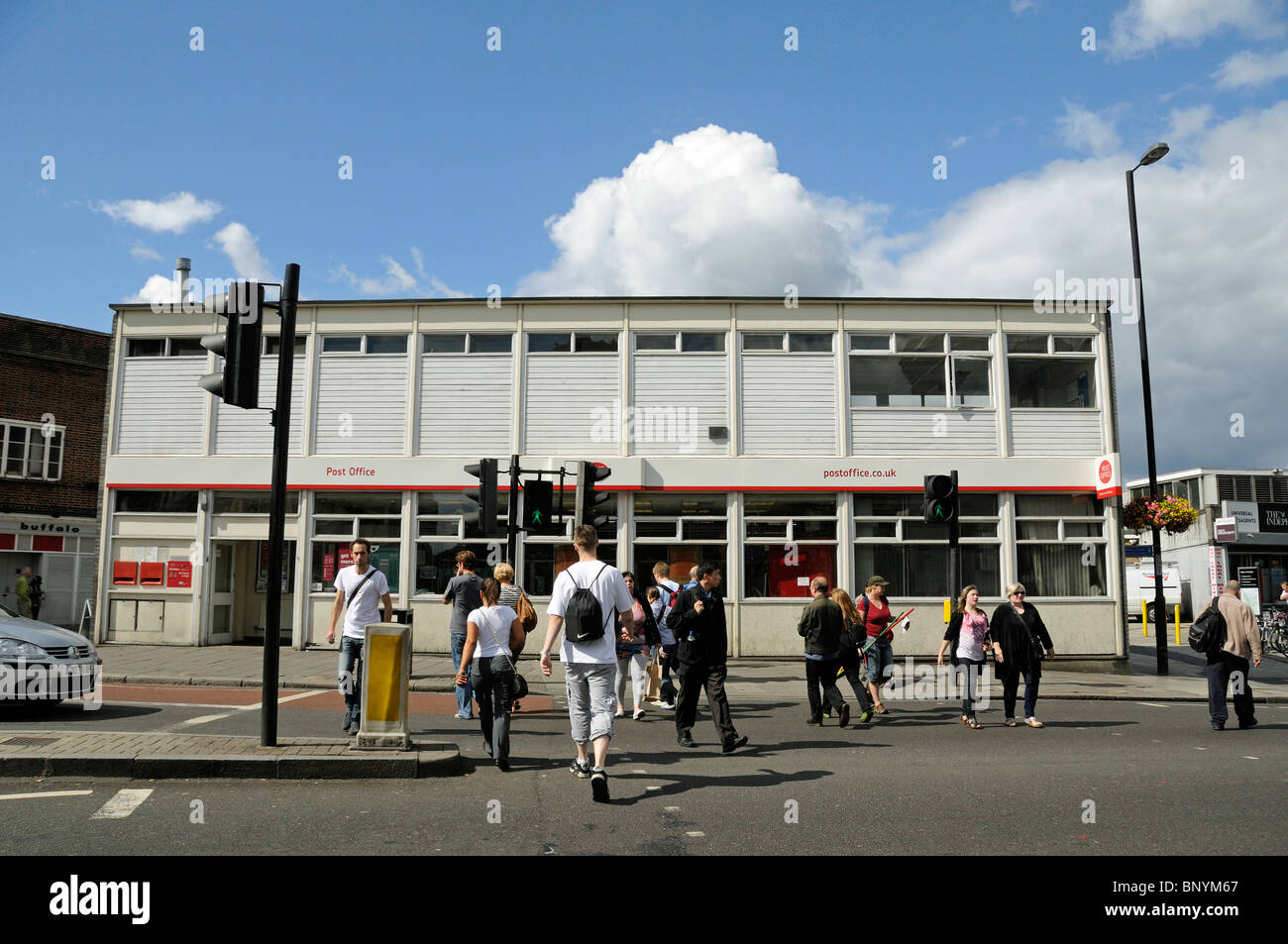 Pedestrians crossing the road at Highbury Corner with Post Office in background, Islington London England Britain UK Stock Photo