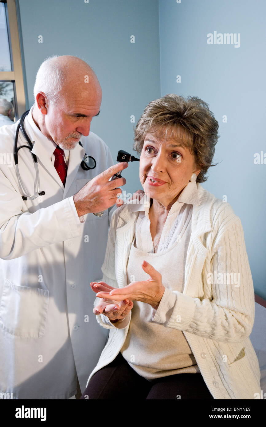 Doctor looking in ear hi-res stock photography and images - Alamy