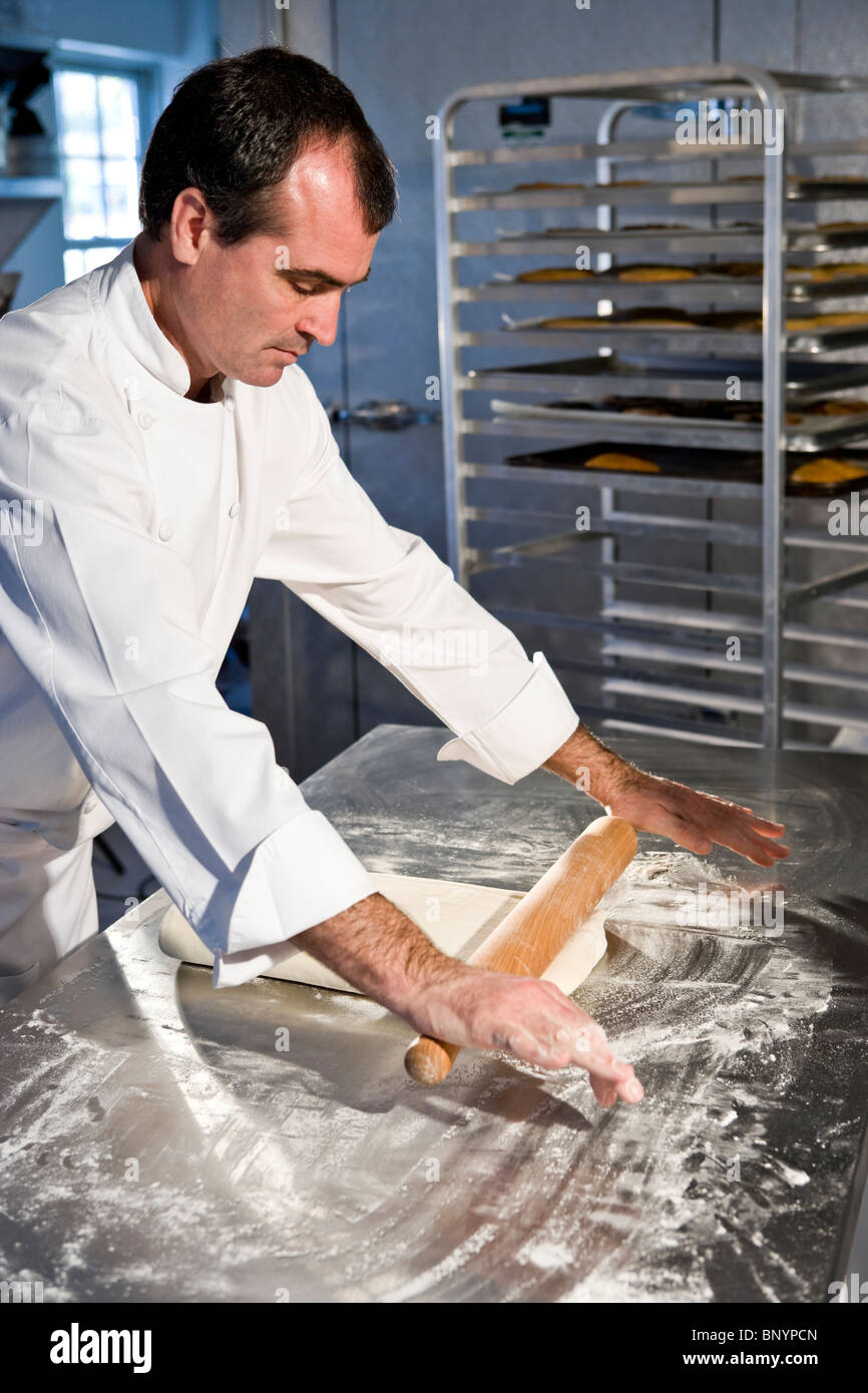 Professional baker rolling dough with pin Stock Photo Alamy