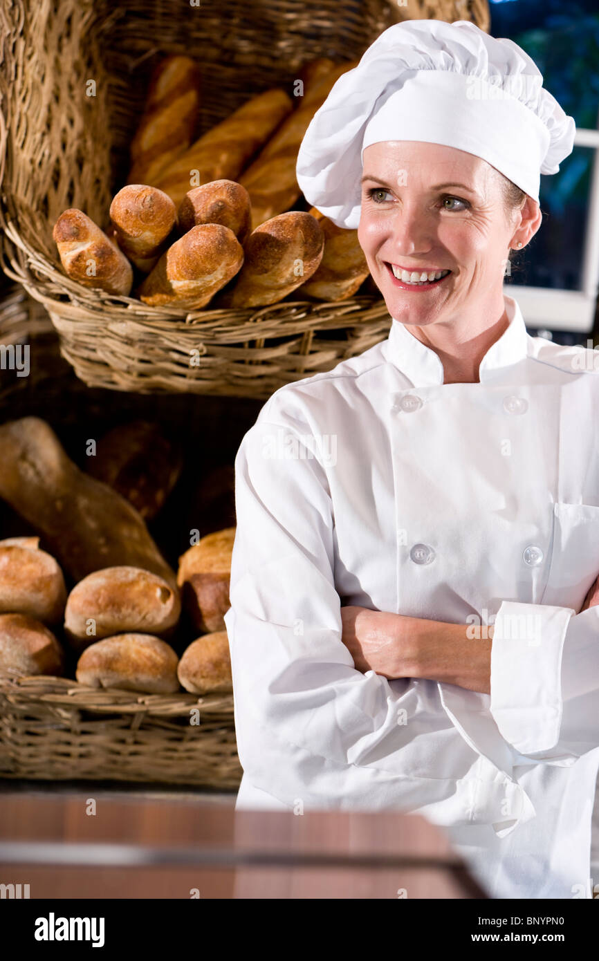 Baker with baskets full of loaves of french bread Stock Photo - Alamy