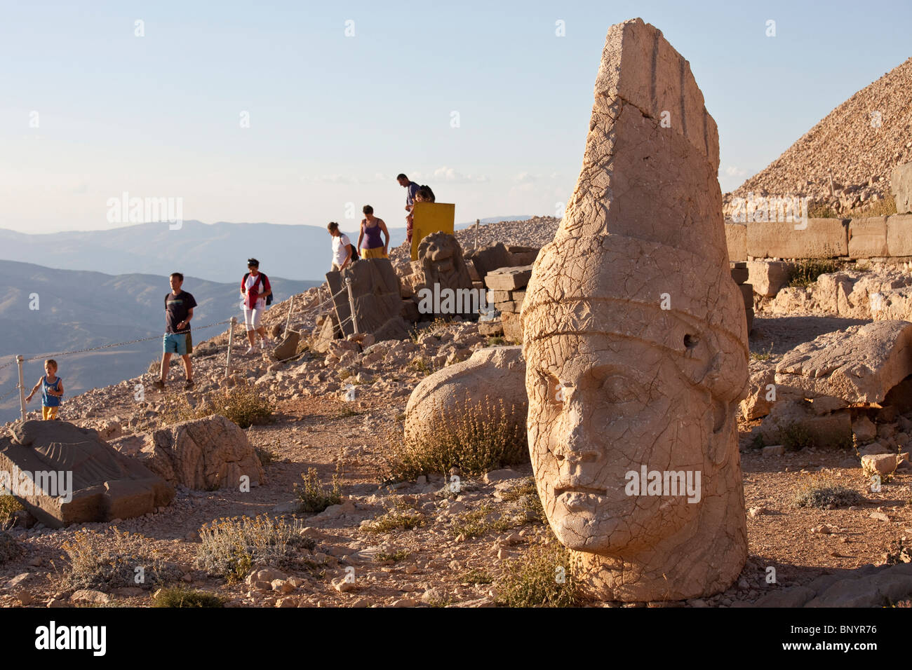 Head of Antiochus, tourists at Mount Nimrut in Turkey Stock Photo