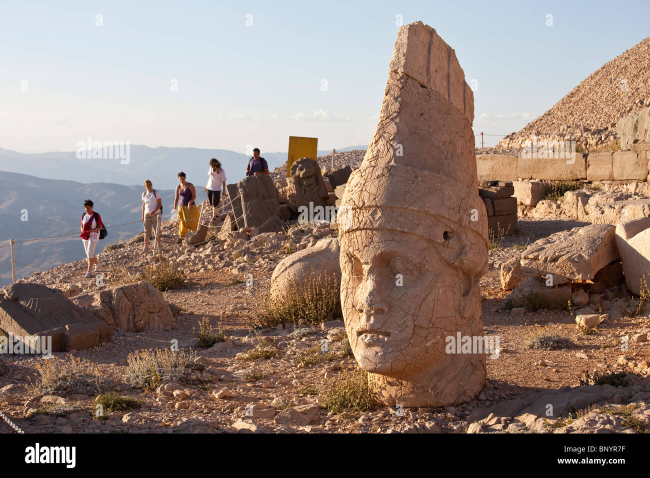 Head of Antiochus, tourists arriving for sunset at Mount Nimrut in Turkey Stock Photo