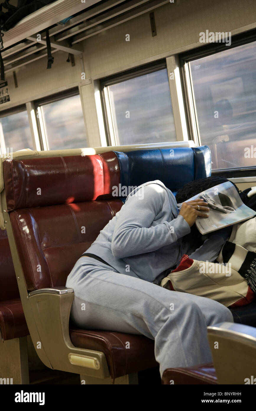Girl trying to sleep in a train, New York City, USA Stock Photo Alamy