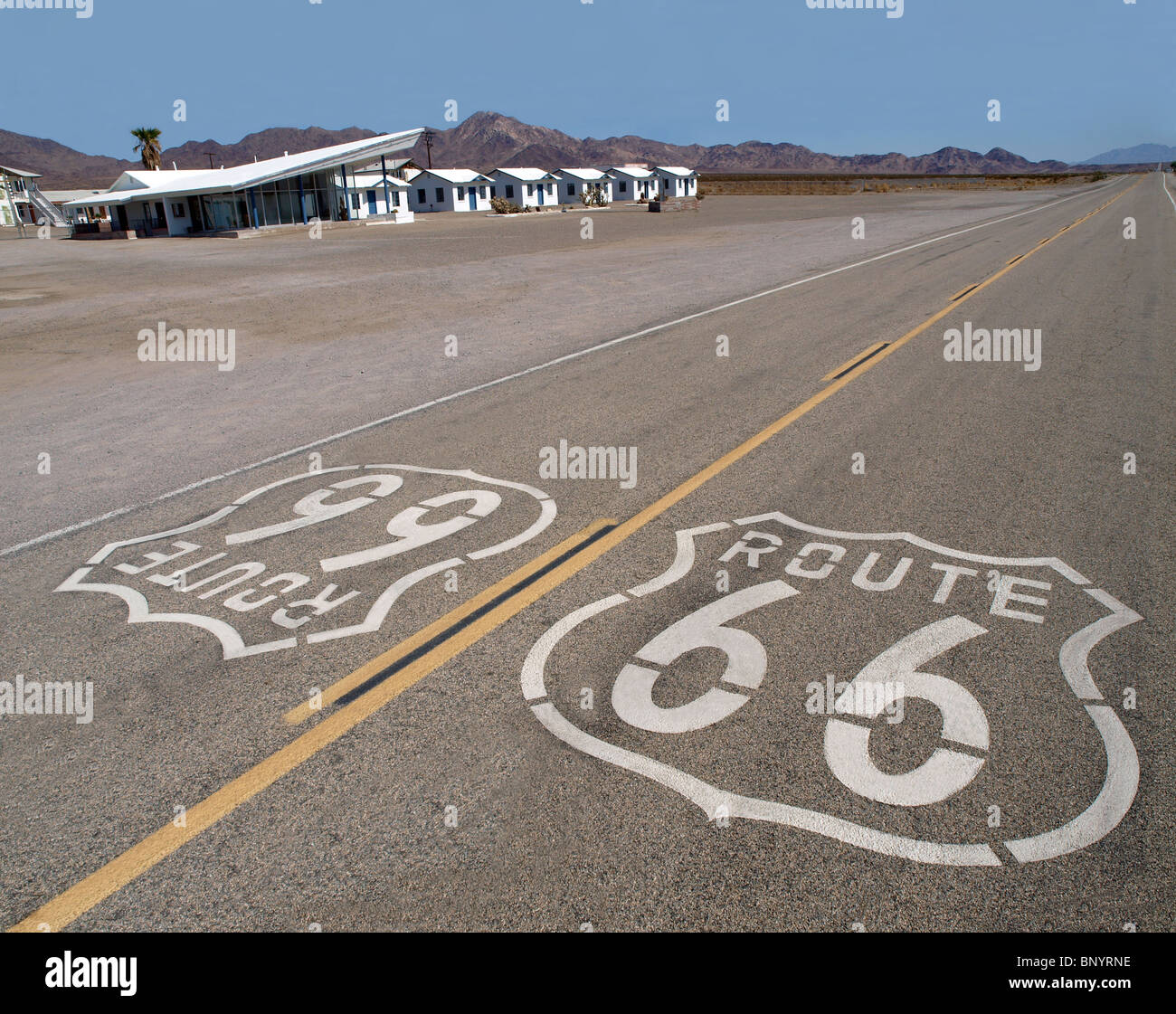 Route 66 sign with googie motel background in California's Mojave Desert. Stock Photo
