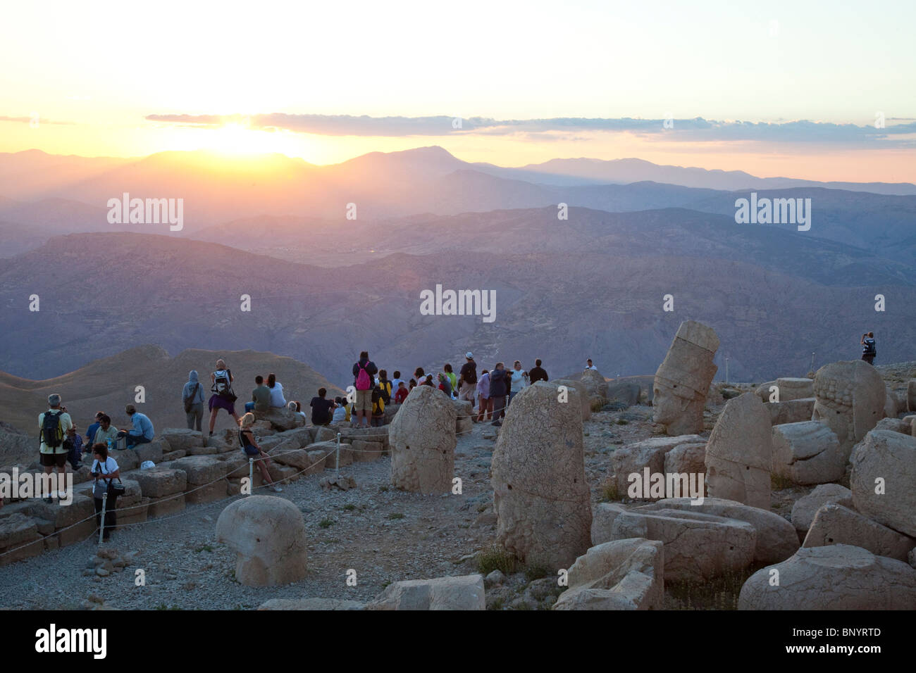 Tourists taking pictures of the sunset at Mount Nimrut in Turkey Stock Photo