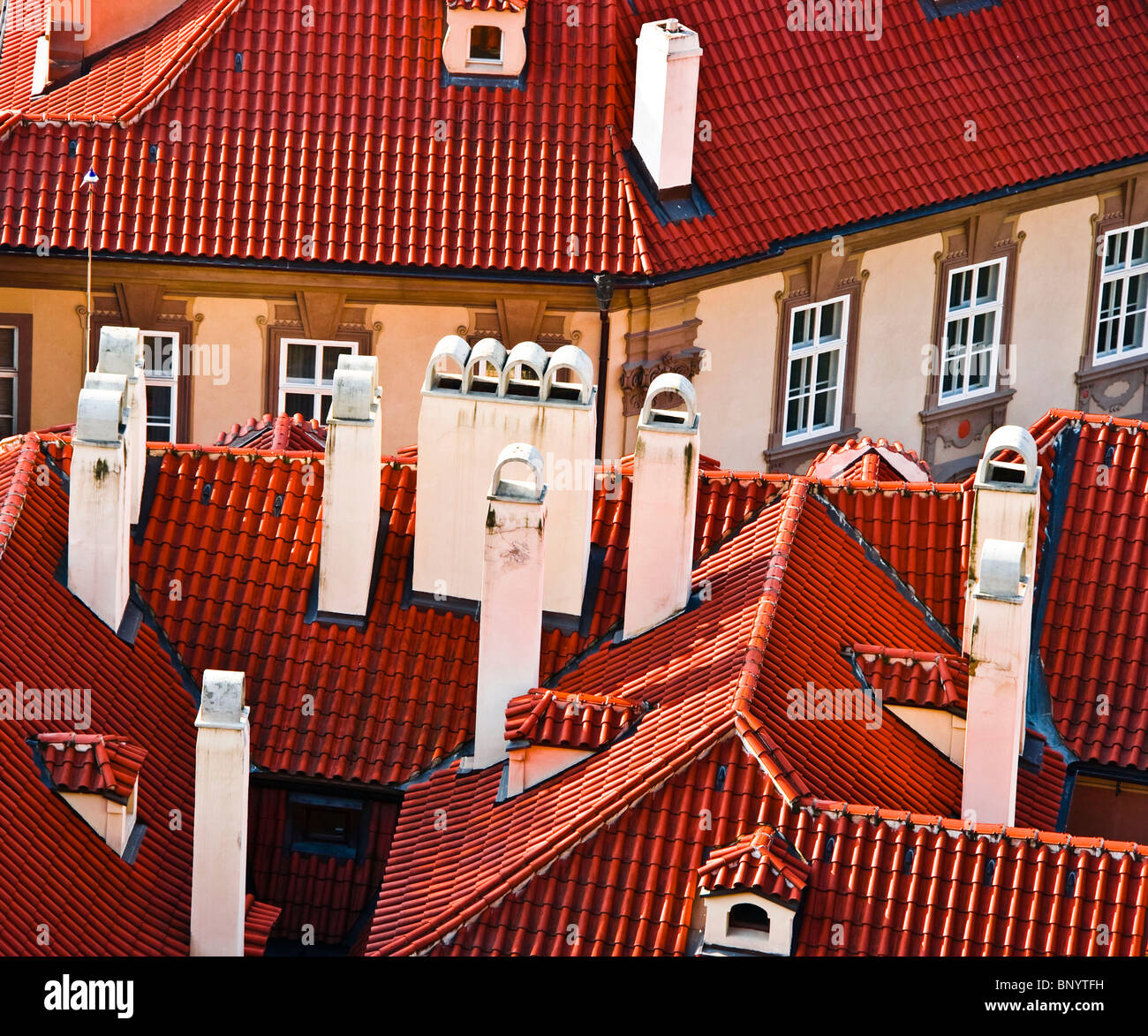 Red tiled baroque rooftops of Mala Strana with numerous chimneys Prague