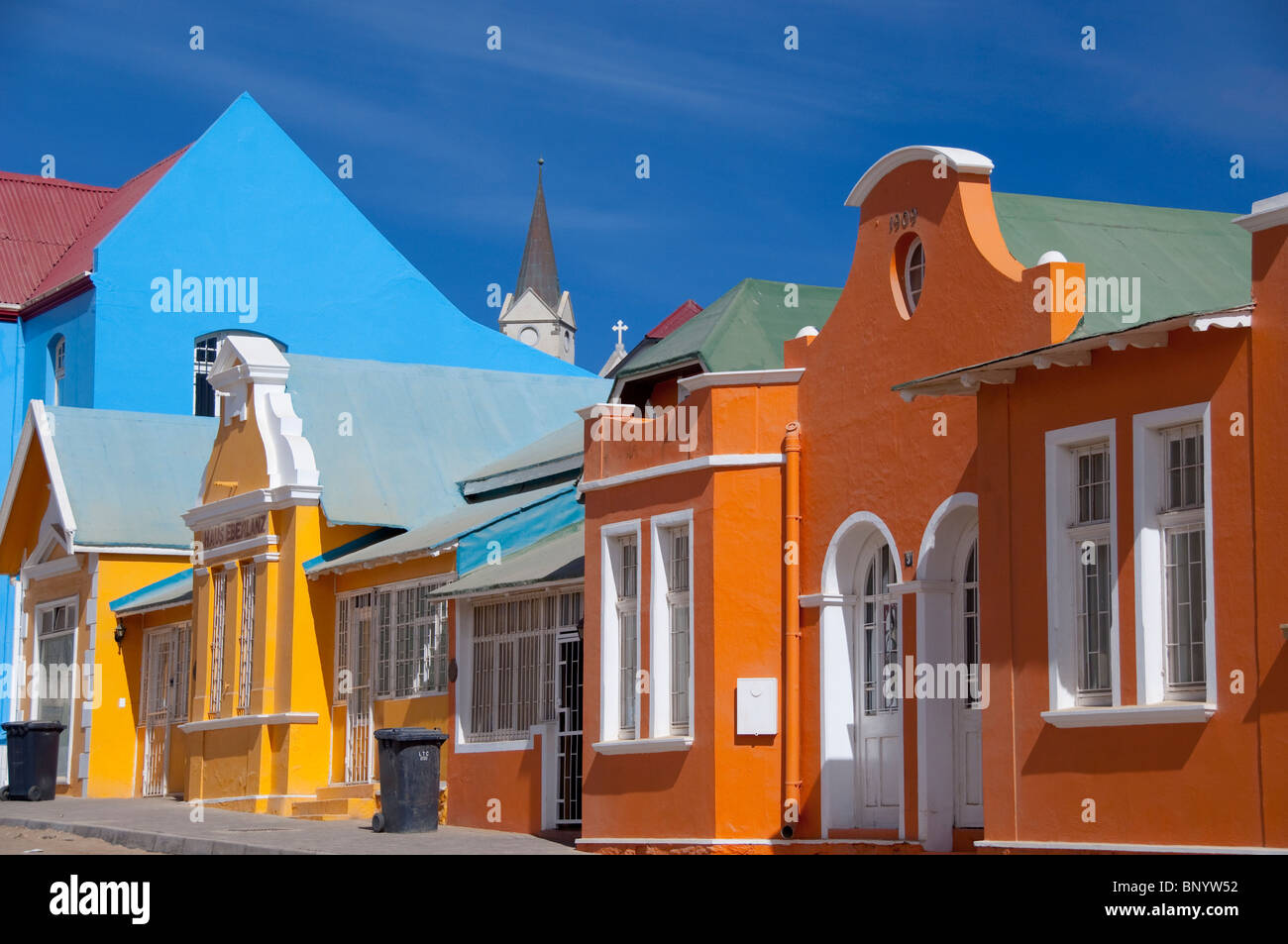 Africa, Namibia, Luderitz. Colorful German style houses along Berg Street, historic church