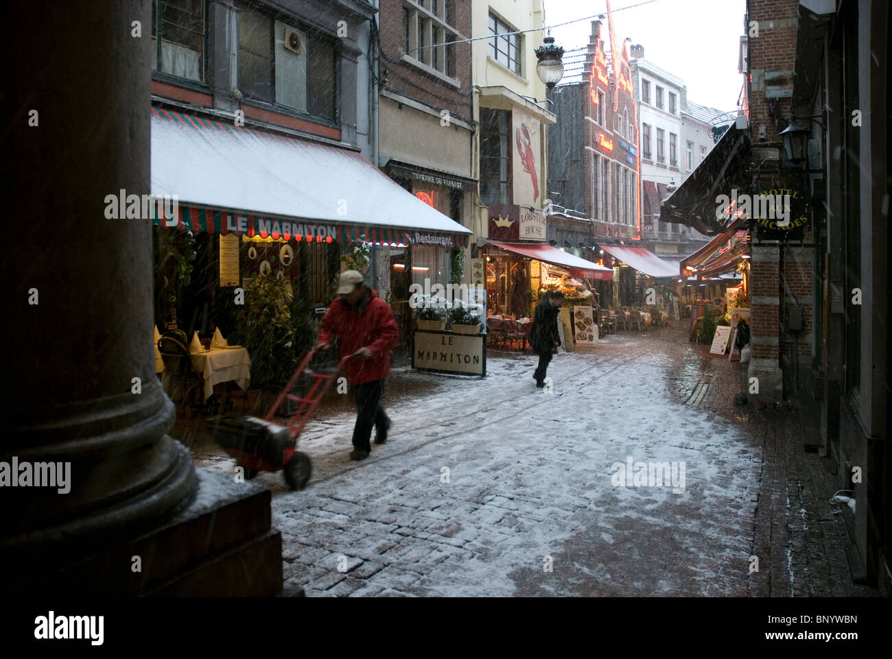 Rue des Bouchersstreet restaurants in Brussels under snow Stock Photo