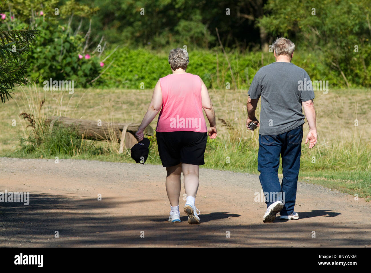 A senior white Caucasian couple walking in the park Stock Photo - Alamy