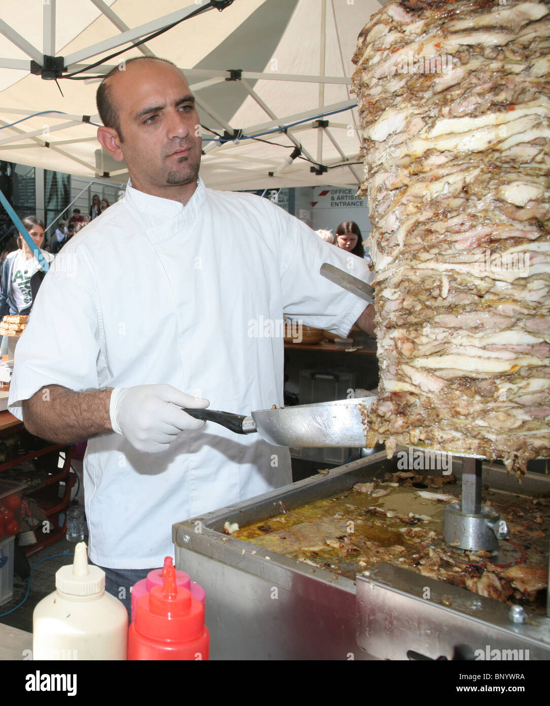 A kebab being roasted and prepared at a food stall at Royal Festival Hall food market, London, UK Stock Photo