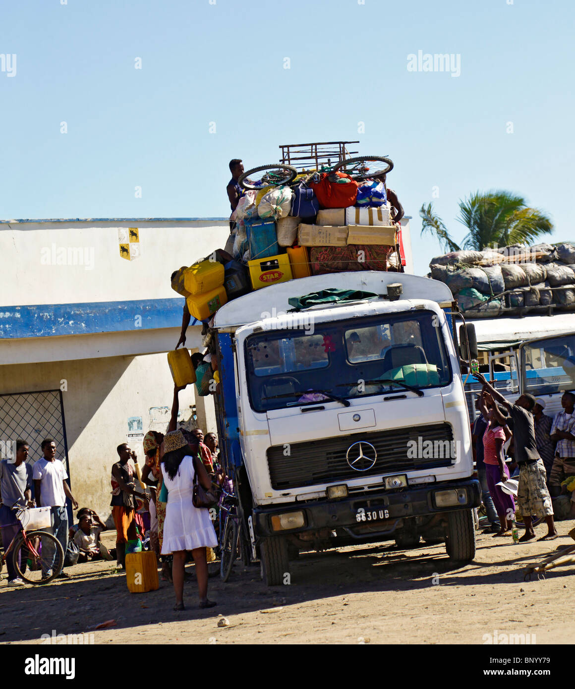 Taxi-brousse at the Toliara depot, with passengers piling their goods onto the roof. Toliary fka Tulear, Atsimo Andrefana, south-west Madagascar. Stock Photo