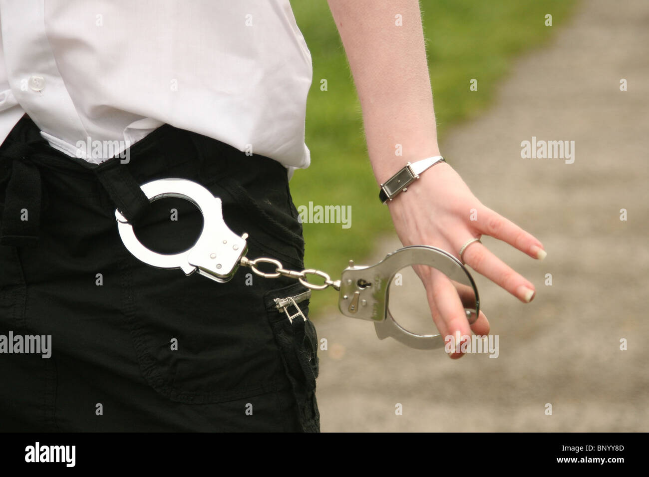Cute red headed girl in handcuffs Stock Photo