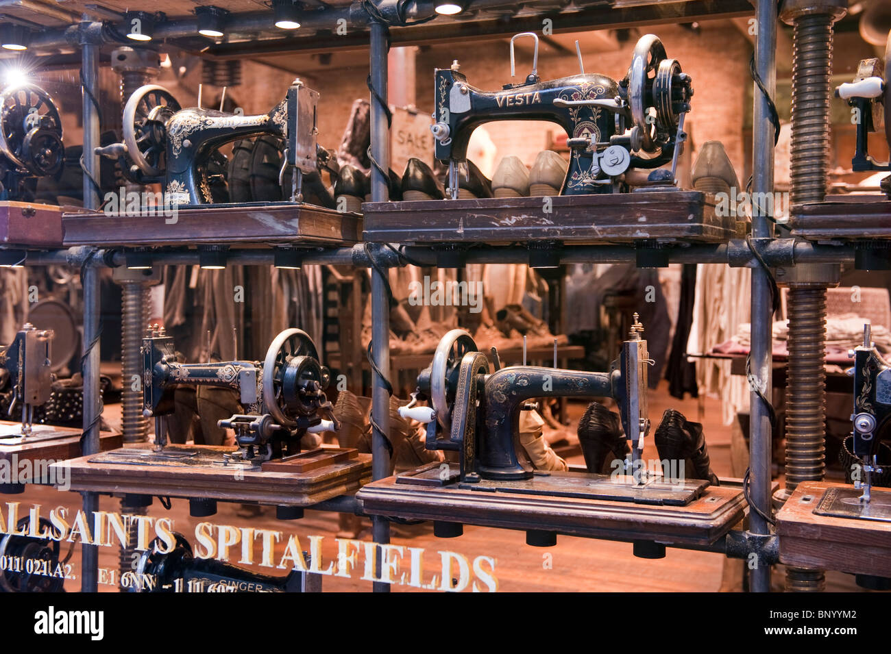 Antique sewing machines on display in a shop window in Brighton Stock