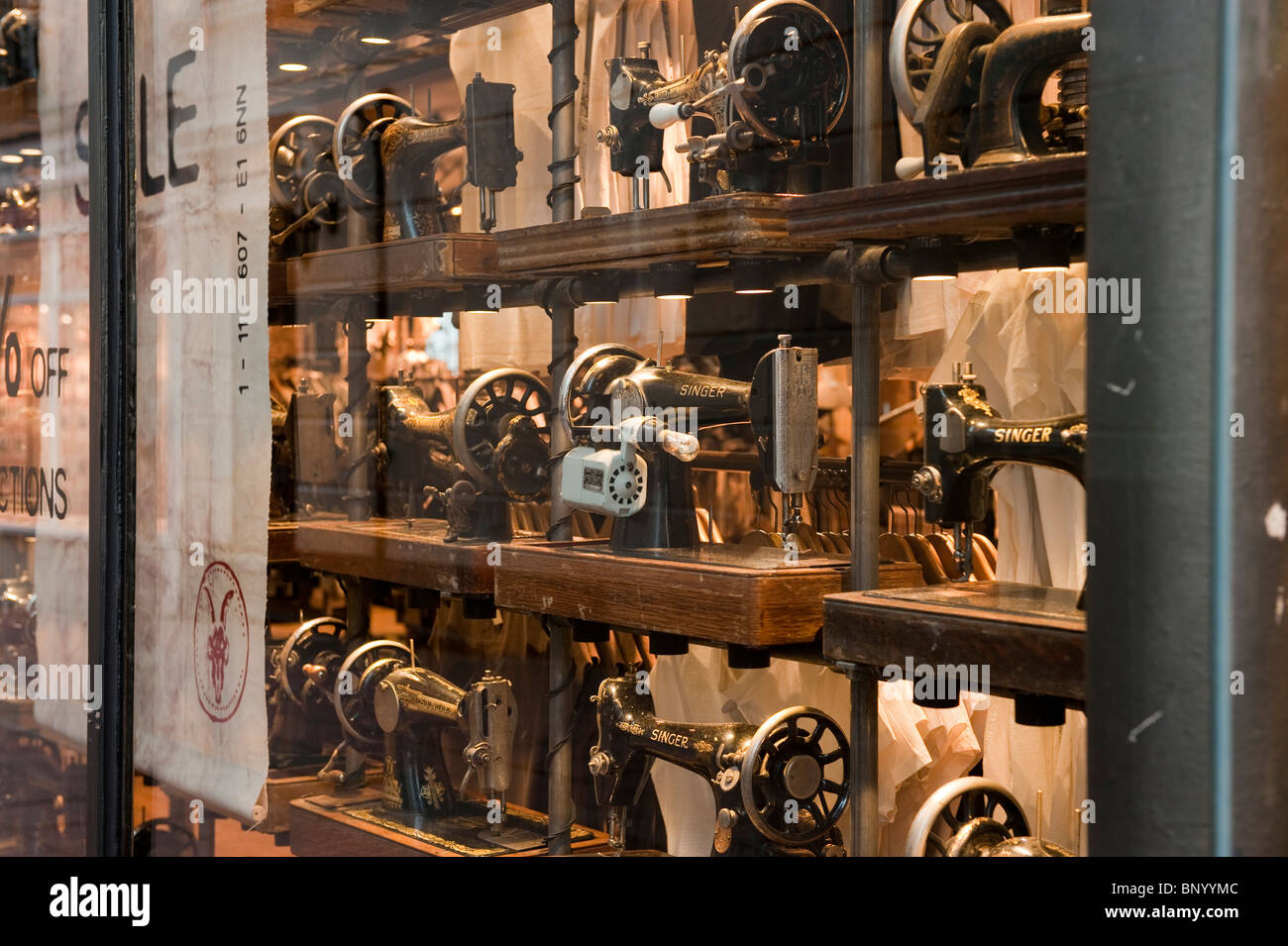 Antique sewing machines on display in a shop window in Brighton Stock Photo