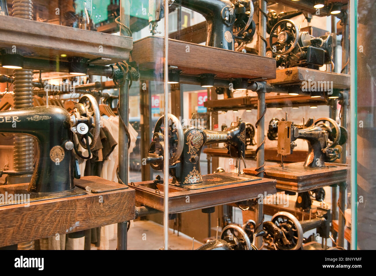 Antique sewing machines on display in a shop window in Brighton Stock Photo