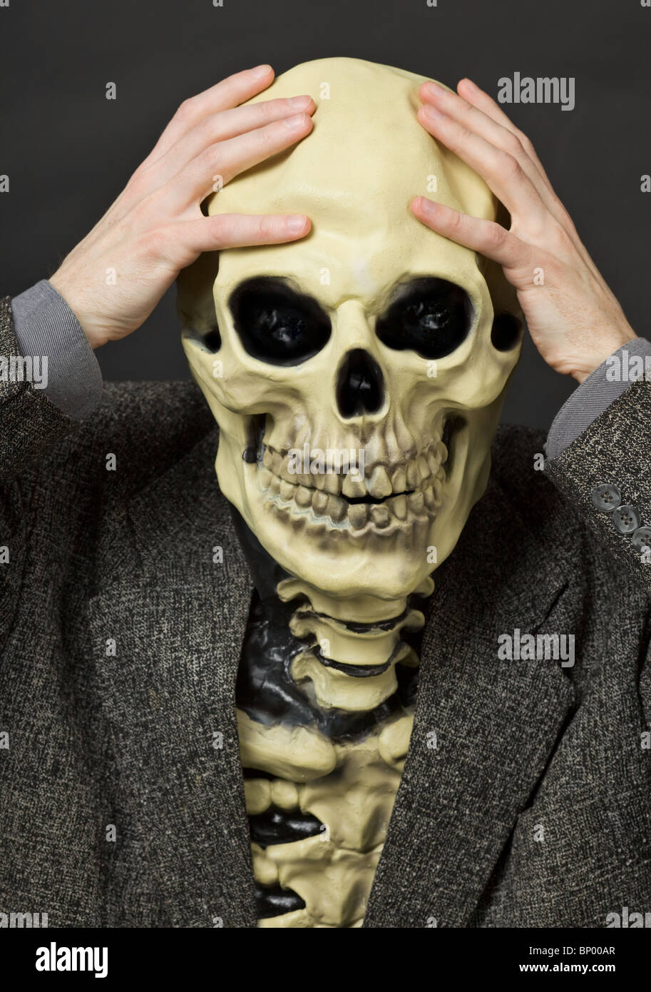 The amusing scared person in a mask - a skull Stock Photo