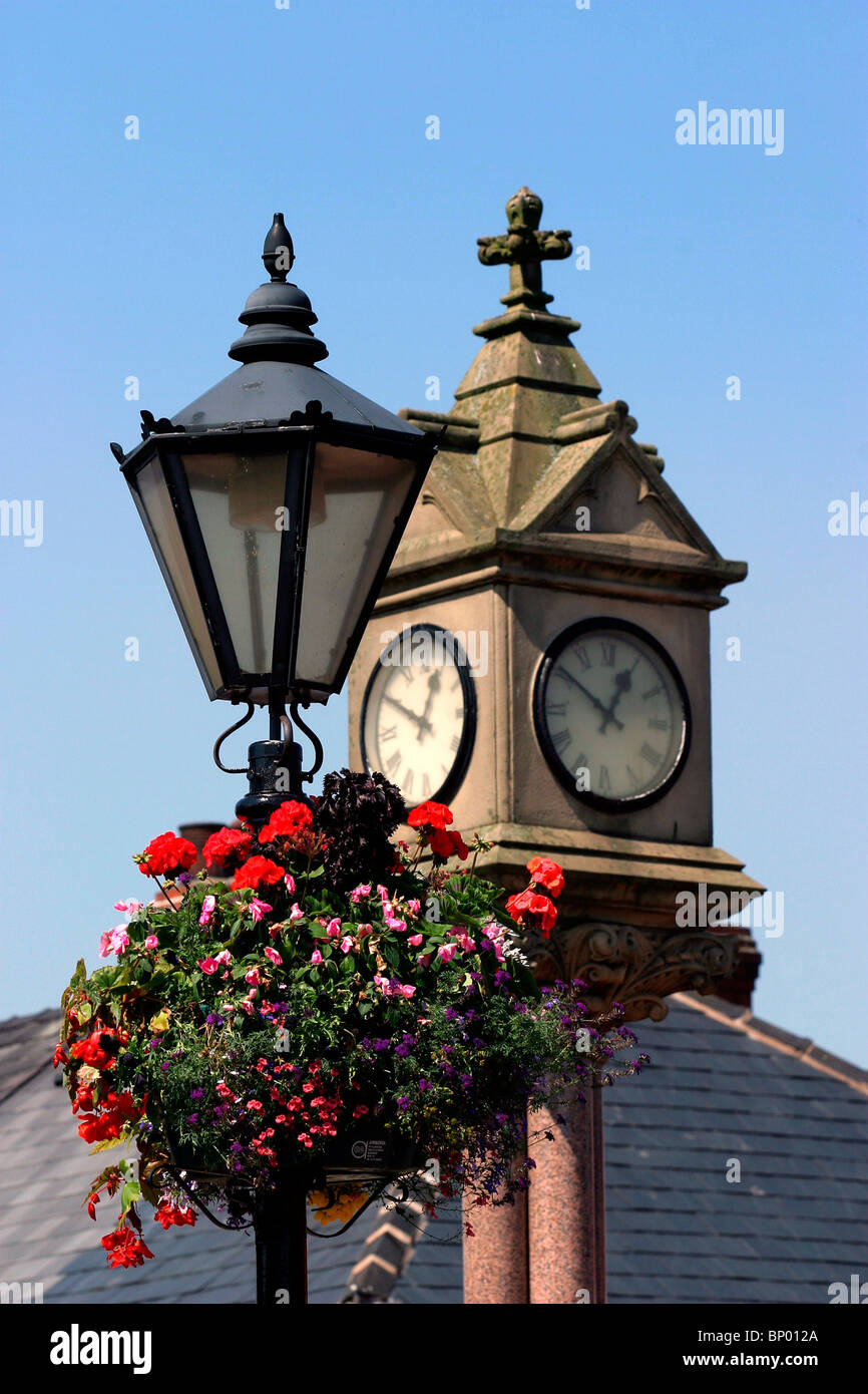 England, Cheshire, Stockport, Reddish, Houldsworth Square, clock tower and hanging basket Stock Photo