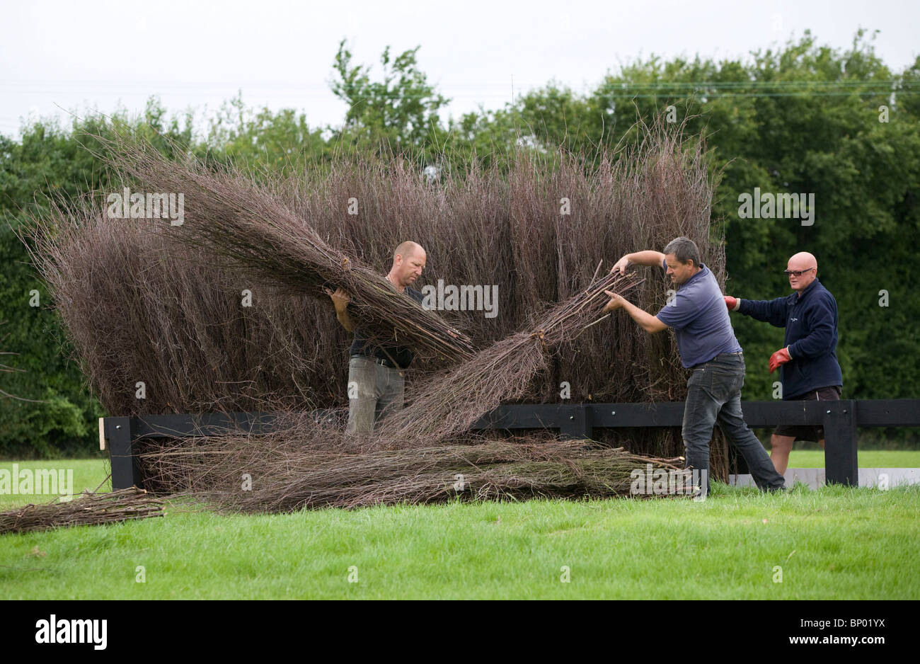 Paul Mant [R] Head Groundsman at Fontwell Park Racecourse builds a new Steeplechase fence with