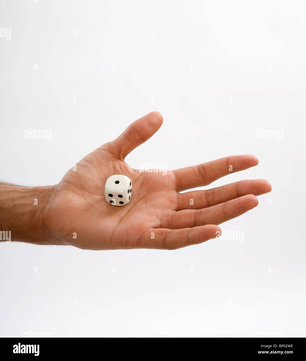 Man holding dice in hand with number one top side up Stock Photo Alamy