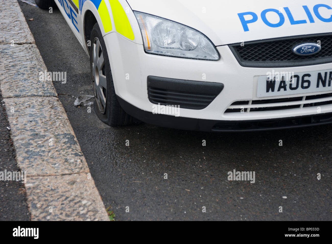 Polic Car with flat tyre, UK Stock Photo