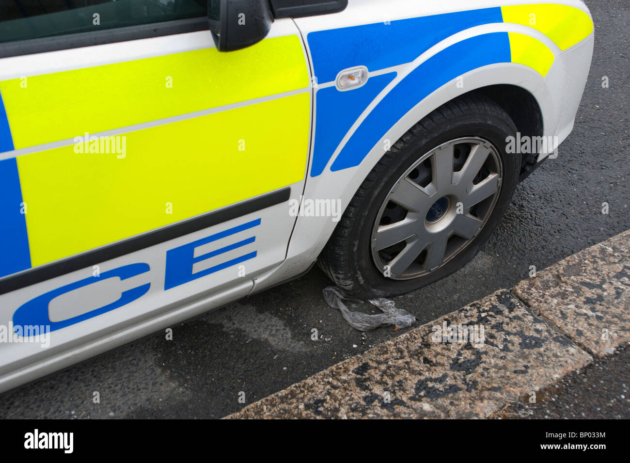 Polic Car with flat tyre, UK Stock Photo