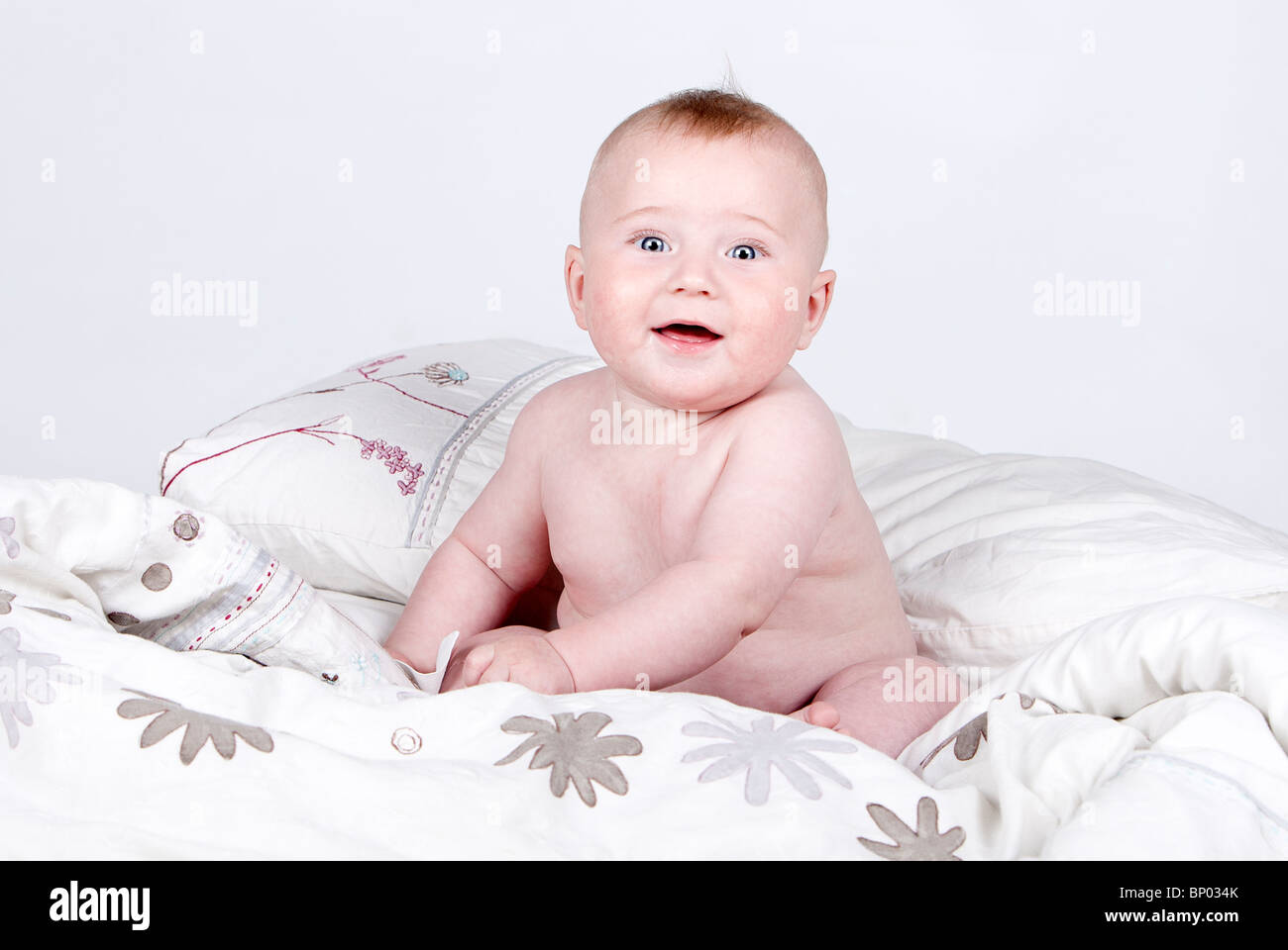 Shot of a Very Cute Baby Boy on Duvet against Grey Background ...