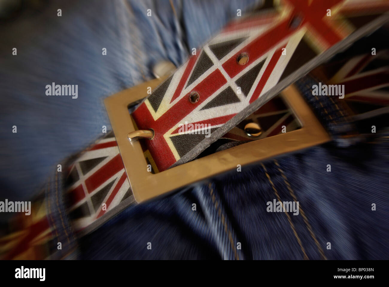 Tighten your belt, Tightening your belt concept featuring the (Union Jack) UK flag design on belt being tightened,cutting costs, Stock Photo