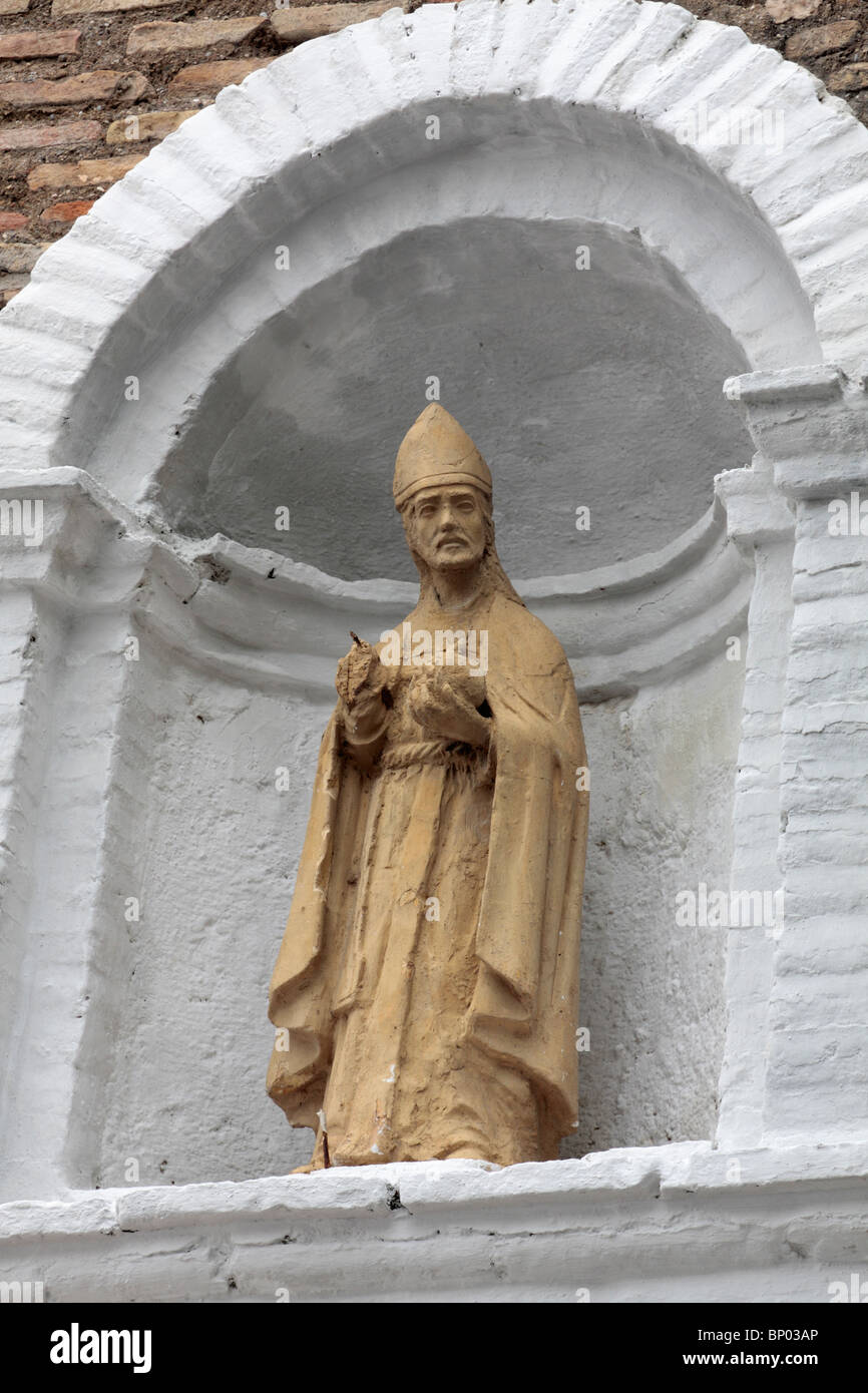 A religious statue possibly St Peter in an alcove in the Albaicin area of Granada Andalucia